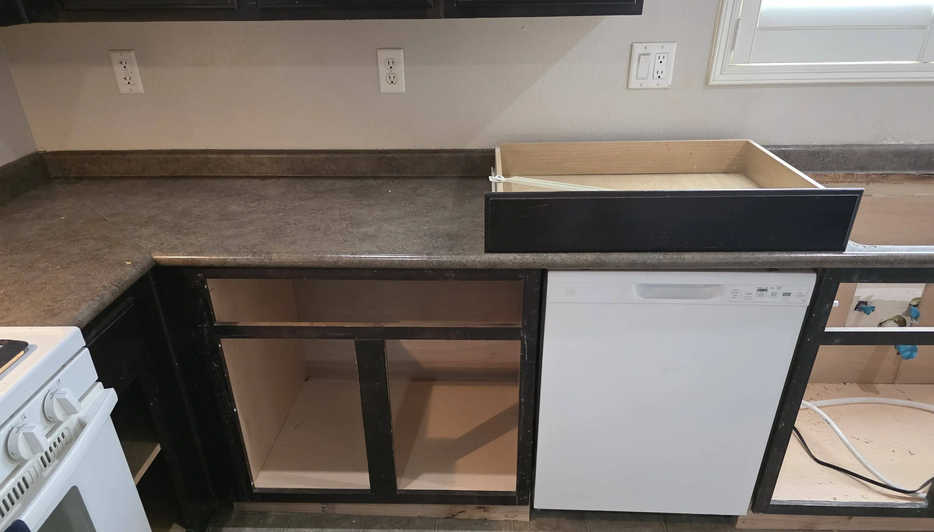 Base cabinets being rebuilt along a kitchen counter