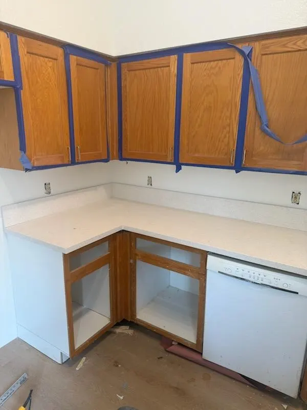 New white counters going in, with the cabinets masked in blue tape